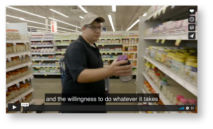 Cover image of the family engagement video. A young man stocking shelves in a supermarket.